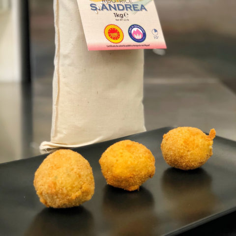 Arancini (Sant’Andrea Baraggia rice PDO croquettes) with shrimps, pink pepper and orange zest.